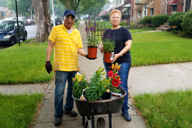 West Pullman residents plant flowers in their yard during a project funded by Habitat for Humanity