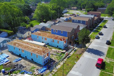 Aerial view of street of houses, two under construction